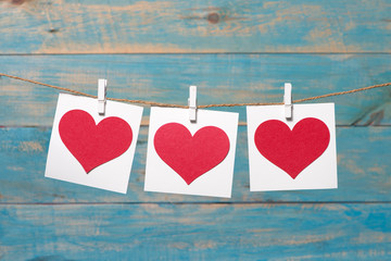 Obraz na płótnie Canvas Love hearts on wooden texture background, valentines day card concept