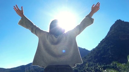 Young woman raising arms to sky in country, super slow motion 240fps
