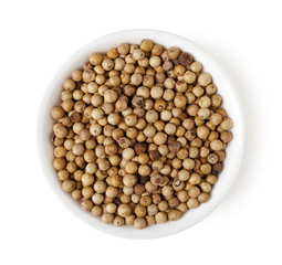 Bowl of white peppers isolated on white, top view