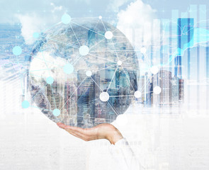 Hand holding globe with network