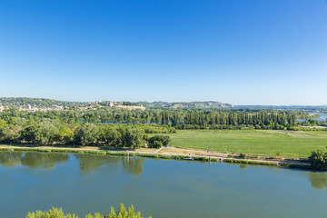 Fototapeta na wymiar Avignon, France. The island on the Rhone River. In the background the city of Villeneuve-lès-Avignon and Fort Saint-Andre