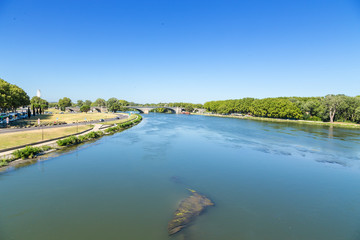 Fototapeta na wymiar Avignon, France. River View of Rhone and the waterfront of St. Benedict Bridge