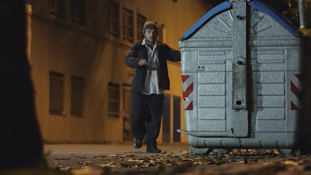 poor man looking for food in the garbage cause the economic crises