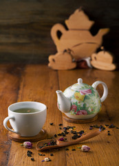 Cup of tea and teapot and assorted herbs