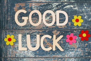 Good luck written with wooden letters on rustic surface
