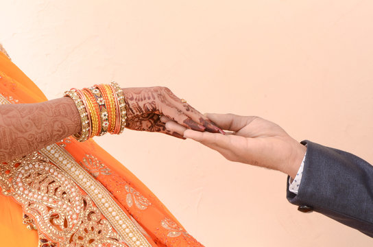 bride and groom joining hands during an indian wedding ritual