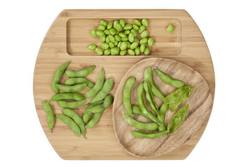 green peas isolated on a wooden plate