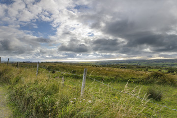Scenic view of landscape against cloudy sky, County Clare, Ireland