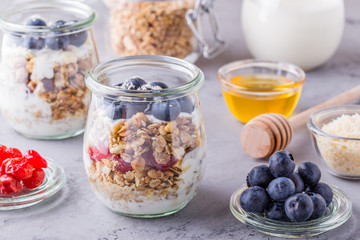 Healthy breakfast - glass jars of oat flakes with fruit,yogurt.