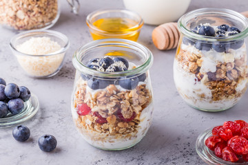 Healthy breakfast - glass jars of oat flakes with fruit,yogurt.