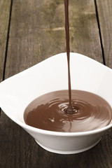chocolate syrup falling in a bowl