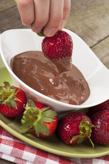 strawberry dipped on a melted chocolate bowl