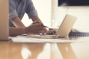 people working with laptop computer and business document