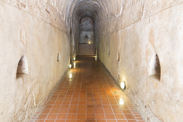 golden buddha statue in cave tunnel