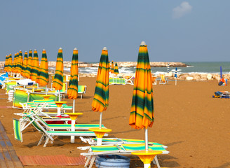 closed Sun umbrellas and loungers in the deserted Beach