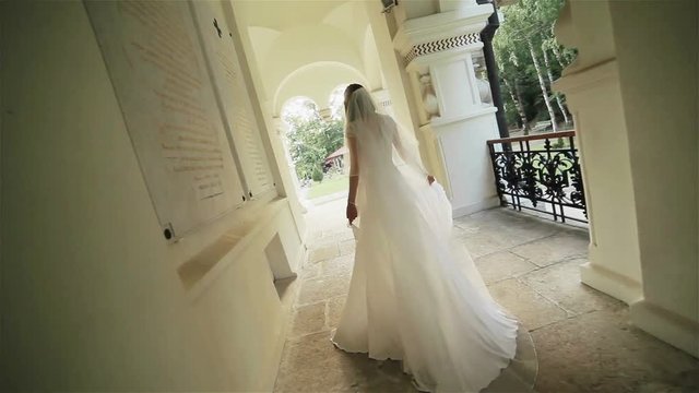 Angry irritated or nervous bride going out of the monastery church worrying about the wedding