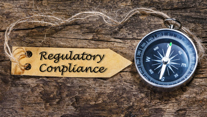 Regulatory Compliance - business tips handwriting on label with