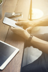 man's hand using smartphone with digital tablet
