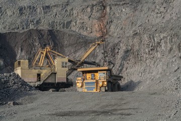 Mining industry the dump truck in career ore loading. June, 2015 Ukraine