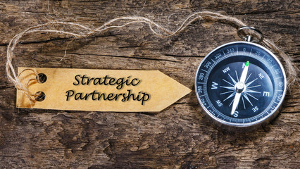 Strategic partnership - business tips handwriting on label with
