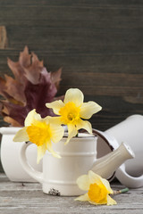 Obraz na płótnie Canvas Yellow flowers in vase on wooden table
