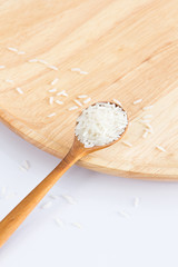Raw and uncooked rice in wooden spoon,shallow Depth of Field,Focus on rice. 