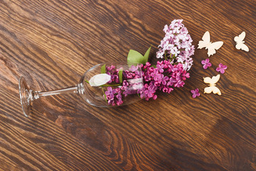 Wineglass with lilacs and butterflies