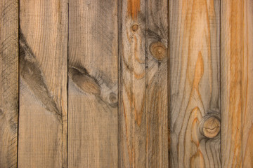 Rural fence from wooden planks with knots. Wood texture