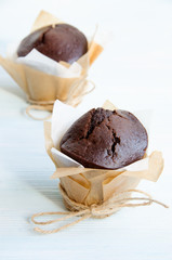 Chocolate muffins on light blue wooden table