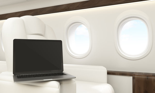 Blank laptop in airplane