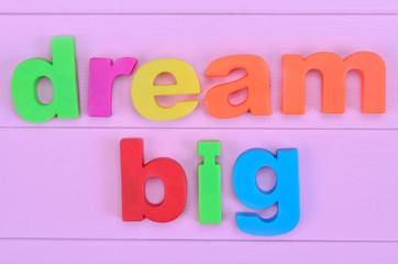 Words Dream Big on pink table