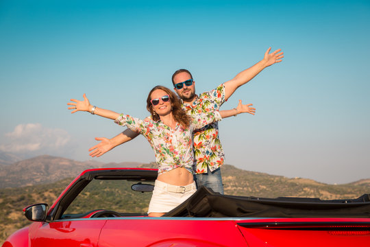 Happy couple travel by car in the mountains