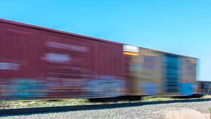 Naklejka premium Passing train with motion blur boxcars