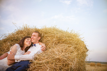 Naklejka na ściany i meble Couple at rural haystacks