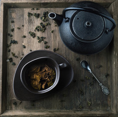 Teapot and cup with green tea