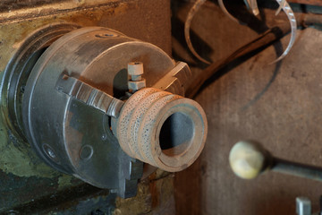 Lathe machine / Old and dirty lathe machine under tungsten light.