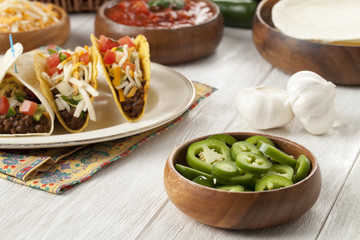 a bowl of a slice green pepper with tacos on the background