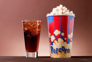 popcorn with a drink on the table