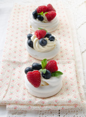 Homemade pavlova meringue cake with fresh berries and whipped cream. Morning. Dessert.