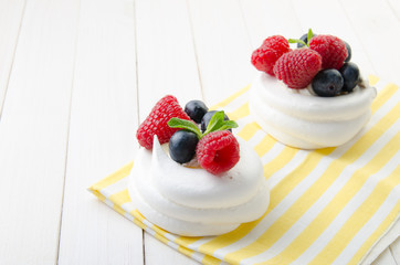 Homemade pavlova meringue cake with fresh berries and whipped cream. Morning. Dessert.