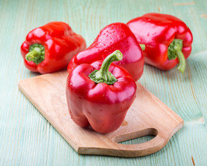 Fresh organic bell peppers on a wooden board