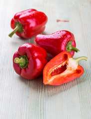 Fresh organic bell peppers on a wooden board