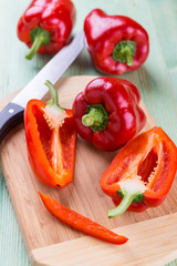 Fresh organic bell peppers on a wooden board