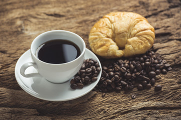 white coffee cup and roasted coffee beans around