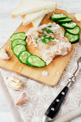 
Ukrainian and Russian national cuisine , the dish is called brawn , boiled pork and turkey in jelly of bouillon with fresh cucumber , salt and spices on a wooden background