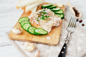 
Ukrainian and Russian national cuisine , the dish is called brawn , boiled pork and turkey in jelly of bouillon with fresh cucumber , salt and spices on a wooden background