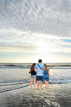 Family Enjoying Time Together On The Beach, Relaxing On Vacation. Jacksonville, USA, Florida.