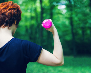 Arm workout with dumbbell outdoors