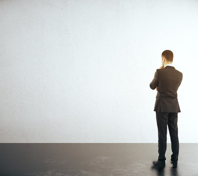 Businessman looking at wall