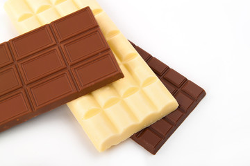 different sorts of chocolate in a stack on white background